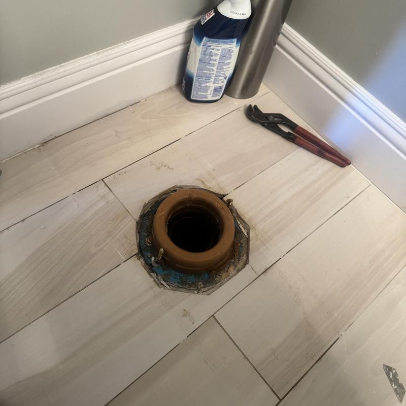 Toilet flange and wax ring exposed for seal repair