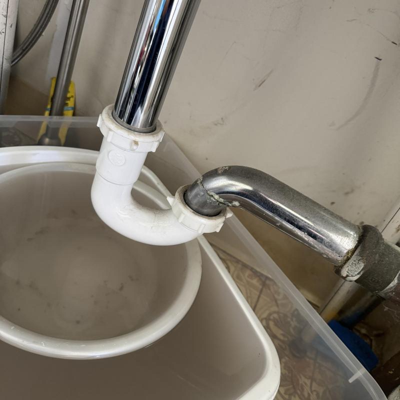 P-trap drain pipe with chrome trap arm under sink