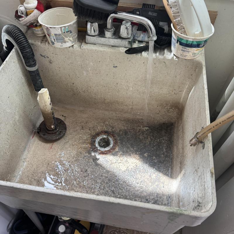 Laundry utility sink drain with flowing water