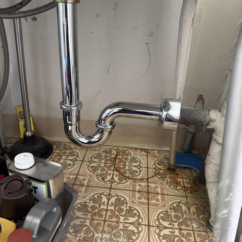 P-trap assembly under sink with new chrome pipes