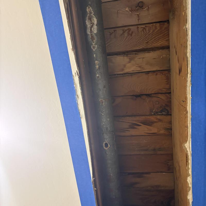Cast iron drain pipe with sheetrock access opened