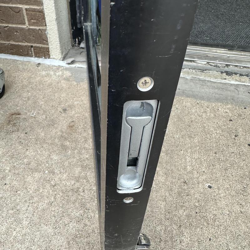 Bottom flush bolt on metal door latch mechanism