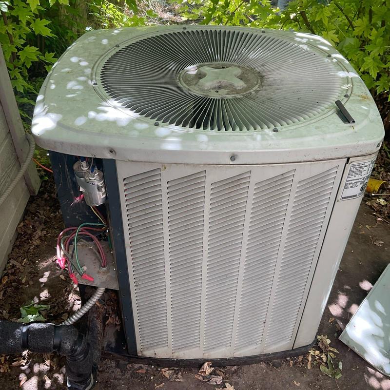 Outdoor air conditioning condenser unit with wiring exposed