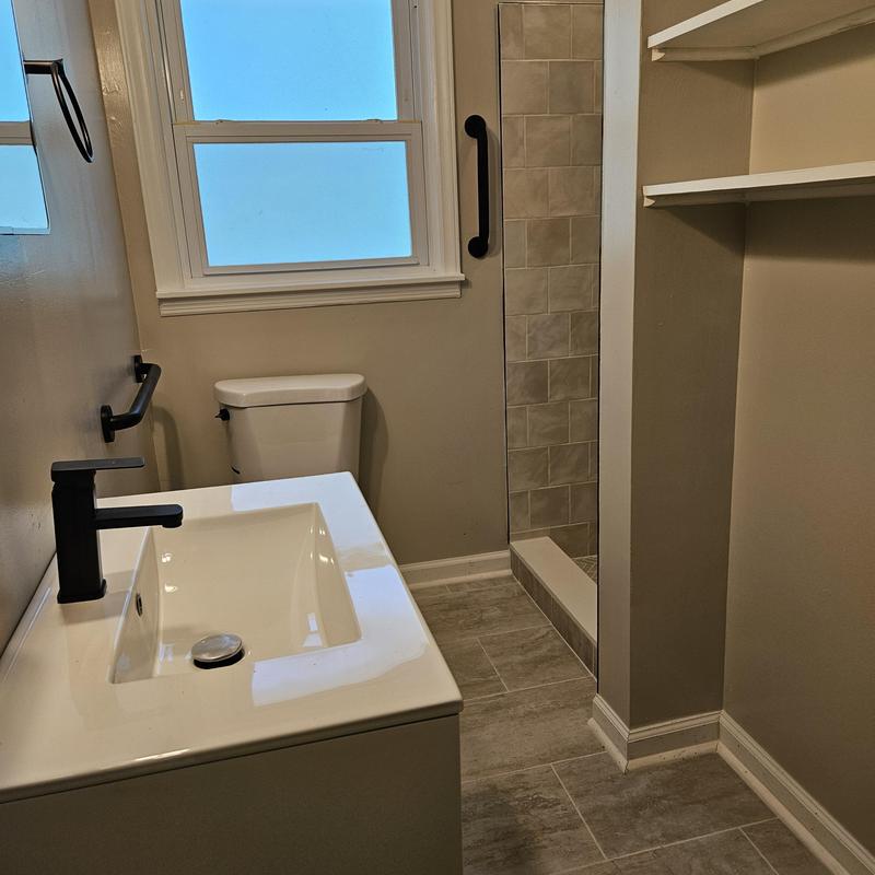 Bathroom vanity and shower with black fixtures Bathroom vanity and shower with black fixtures