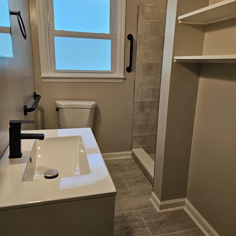 Bathroom sink vanity and toilet with towel bars Bathroom sink vanity and toilet with towel bars