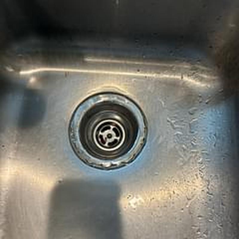 Basket strainer installed in stainless steel kitchen sink Basket strainer installed in stainless steel kitchen sink