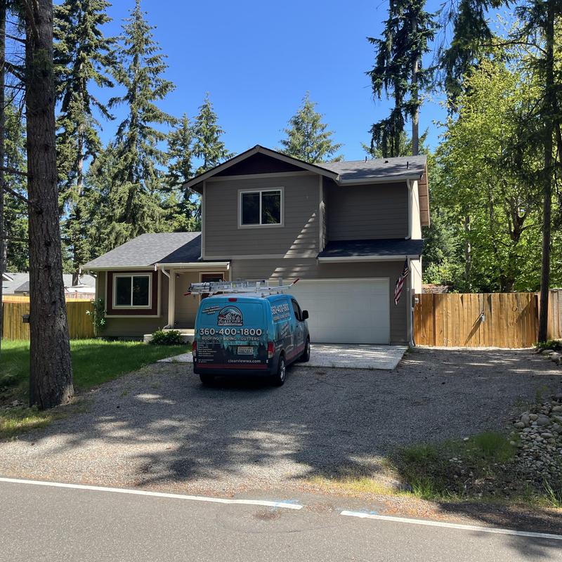Residential roof with leak inspection in wooded area Residential roof with leak inspection in wooded area