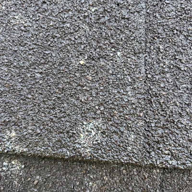Asphalt shingle roof with hail and granule damage