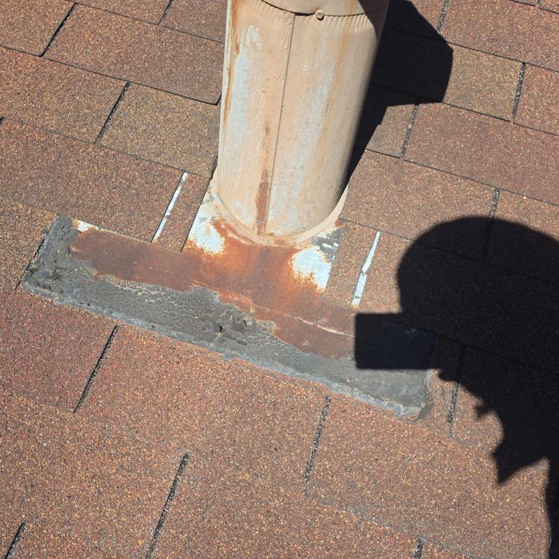 Vent pipe flashing with rust and sealant damage Vent pipe flashing with rust and sealant damage