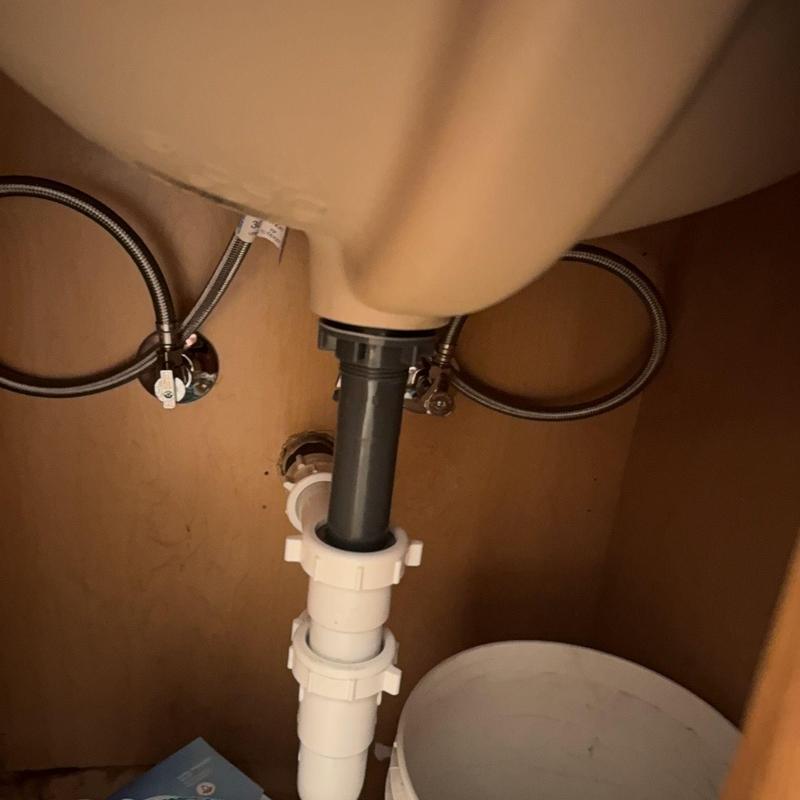 Lavatory drain assembly with pop-up and supply lines under sink