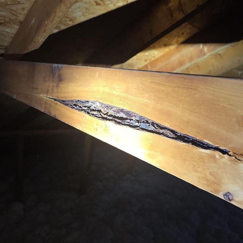 Roof truss wood beam with large structural crack Roof truss wood beam with large structural crack
