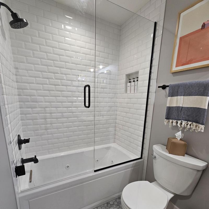 Bathroom tub and shower with glass door and tiles Bathroom tub and shower with glass door and tiles