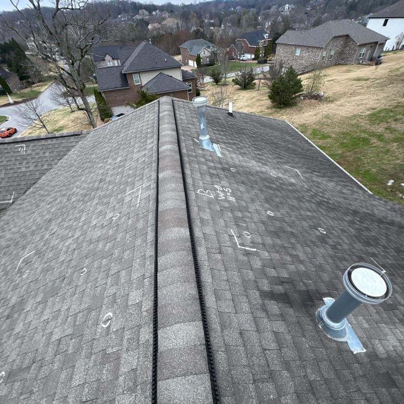 Roof shingles with hail damage markings and ridge vent