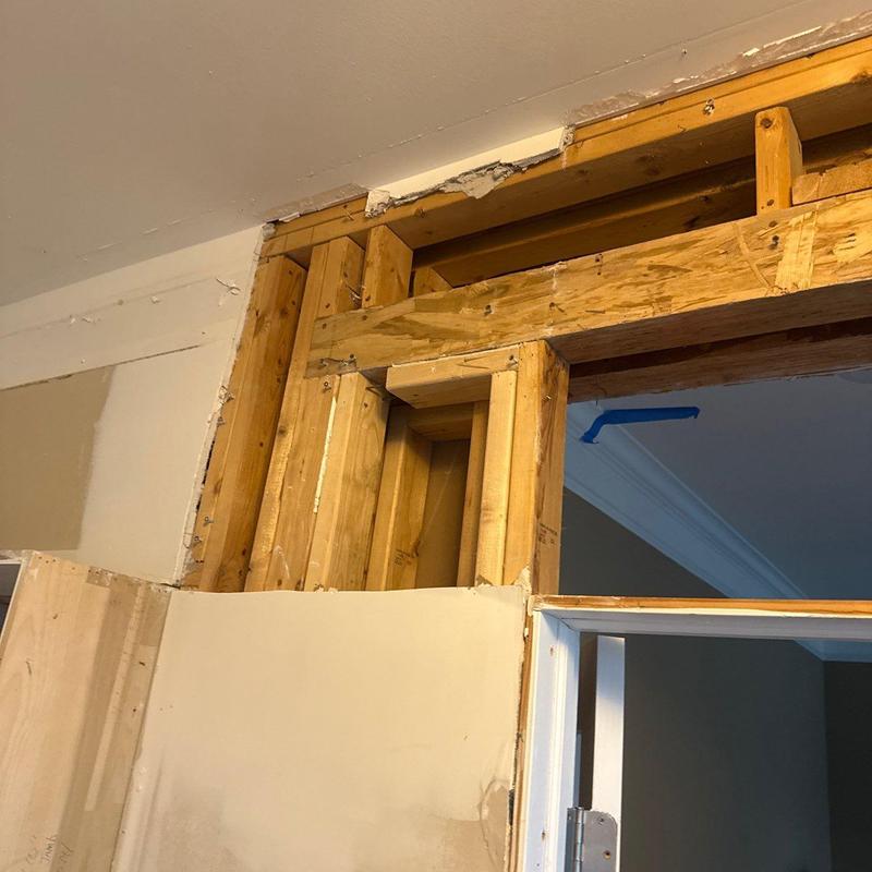 Wood framing exposed above interior doorway during renovation