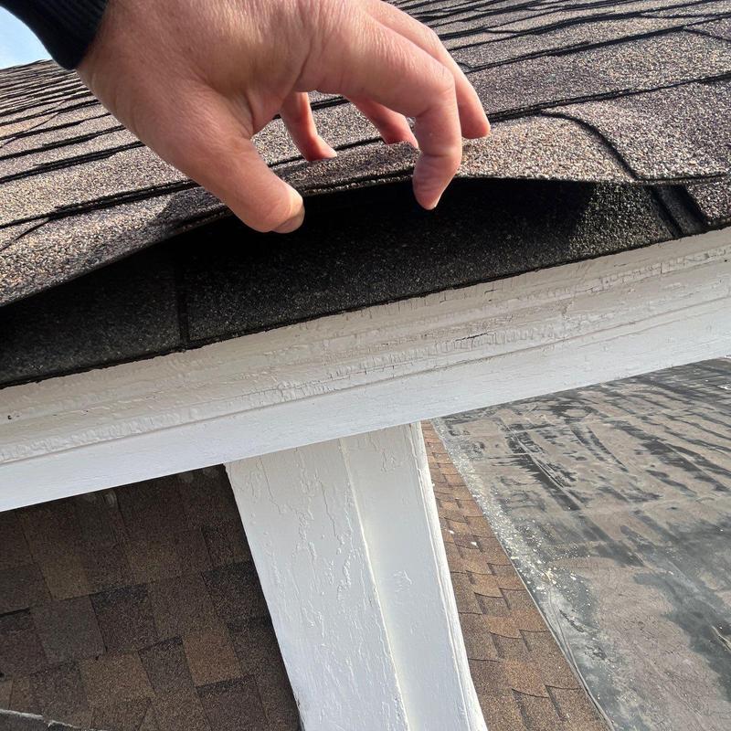 Asphalt shingle roof lifted for inspection