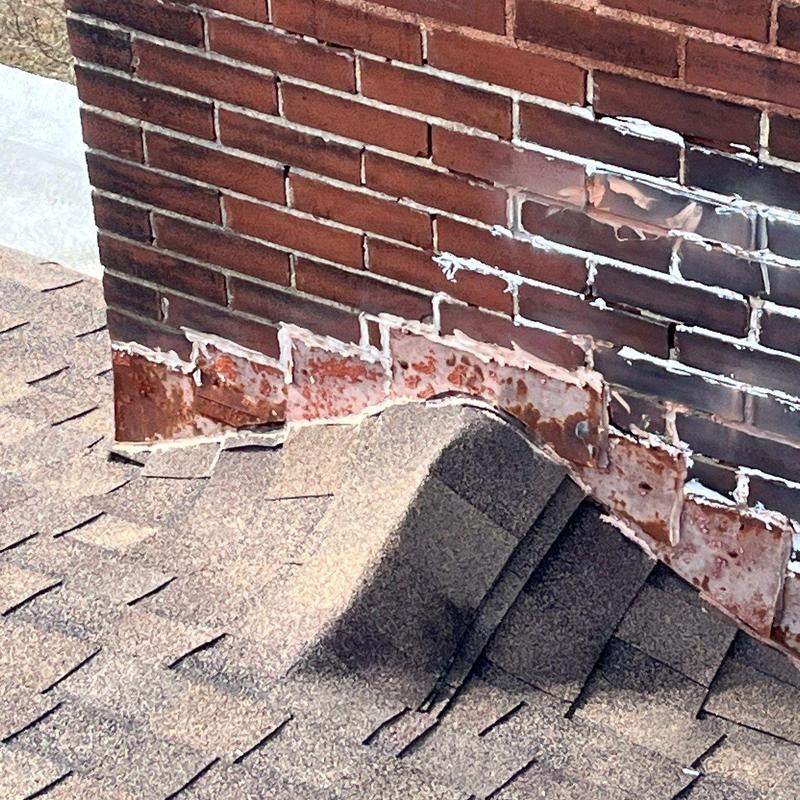 Flashing on brick chimney with rust and wear