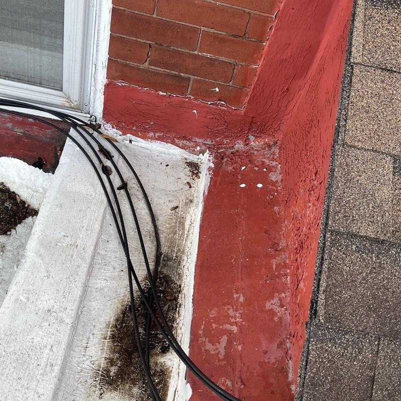 Roof flashing with weathered sealant and wiring nearby