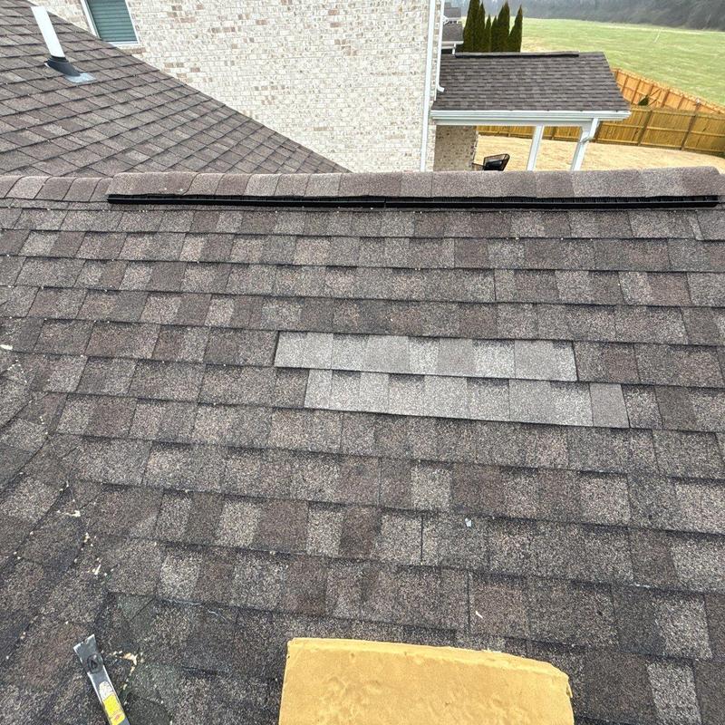 Roof shingles with hail damage and patch repairs
