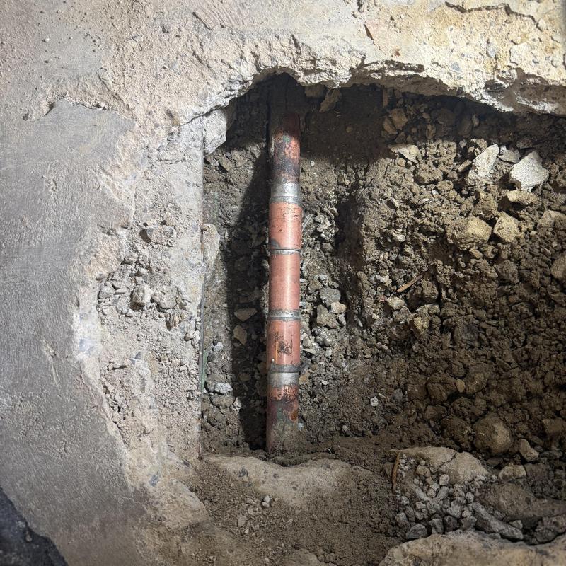 1-inch copper water line with fittings in dirt trench 1-inch copper water line with fittings in dirt trench
