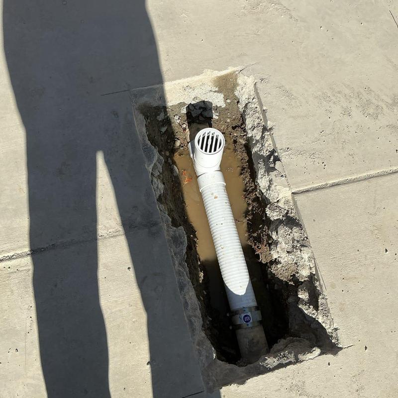 Area drain pipe with installed grate in concrete trench