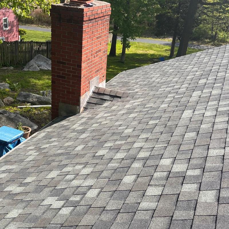 Asphalt shingle roof with brick chimney flashing installation Asphalt shingle roof with brick chimney flashing installation