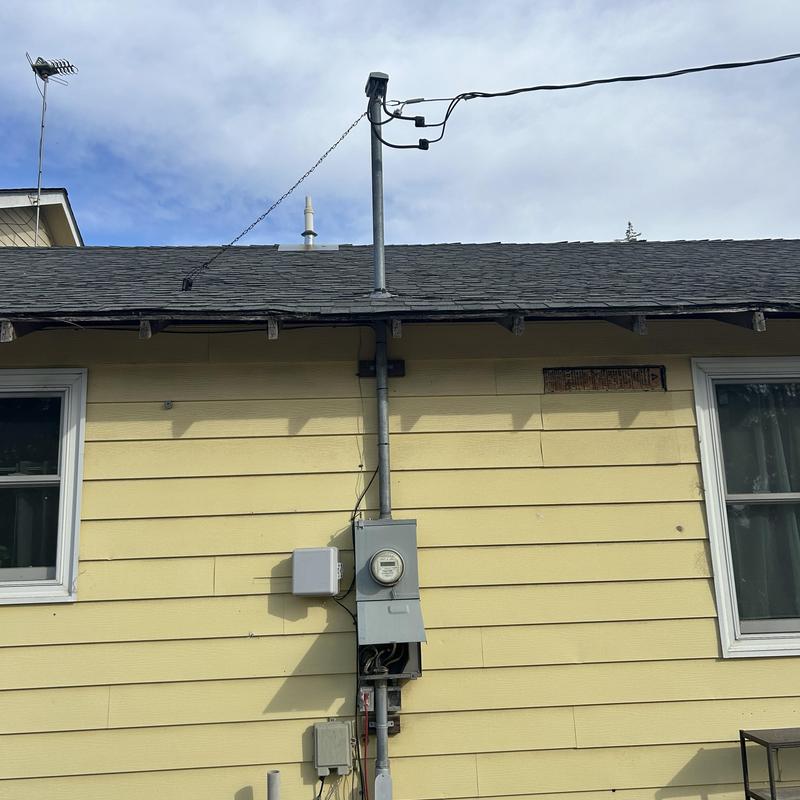 Electric meter and service panel on house exterior