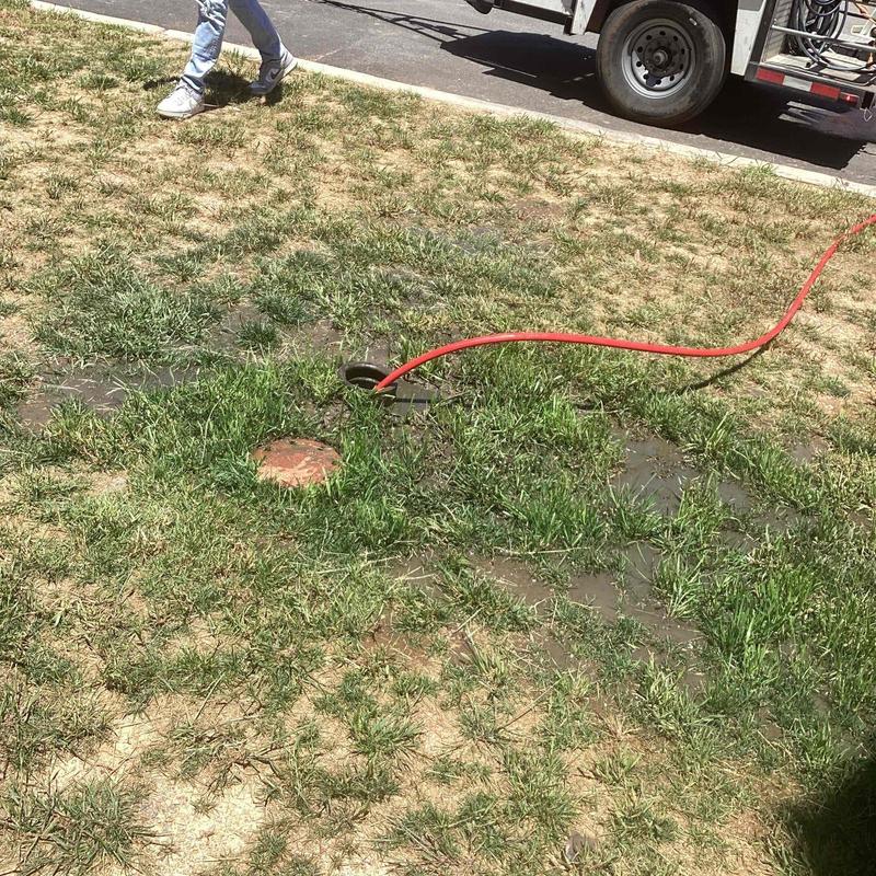 Sewer line with jetting hose and grass area