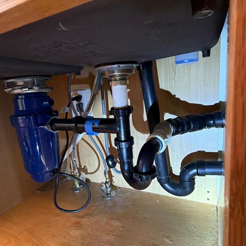 Garbage disposal and plumbing lines under sink in Lafayette