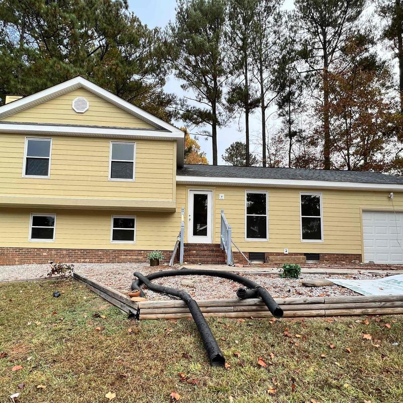 Exterior vinyl siding installation on yellow house Exterior vinyl siding installation on yellow house