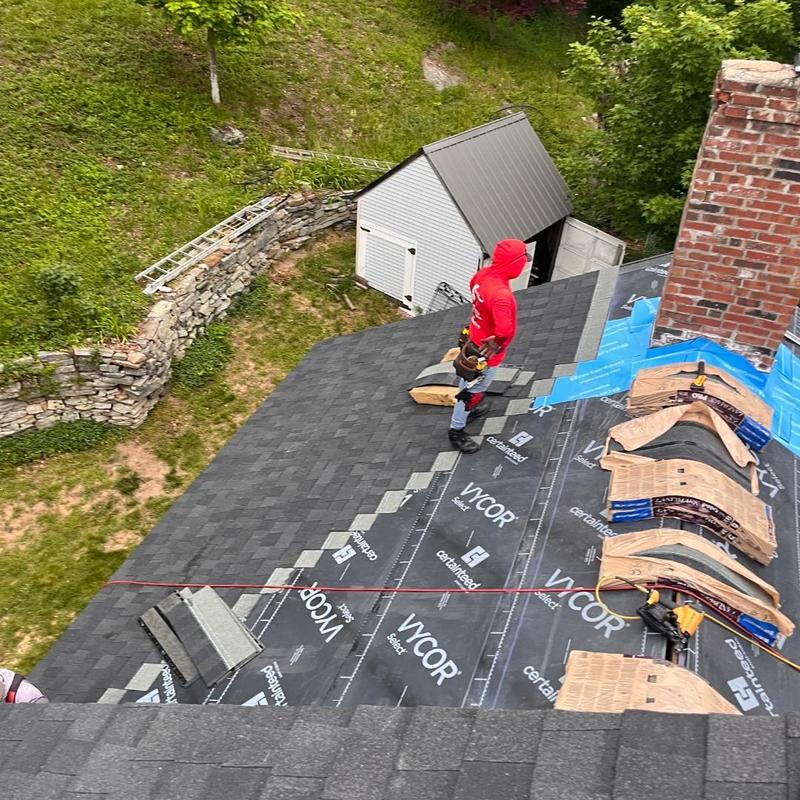 Asphalt shingle roof installation with chimney flashing Asphalt shingle roof installation with chimney flashing