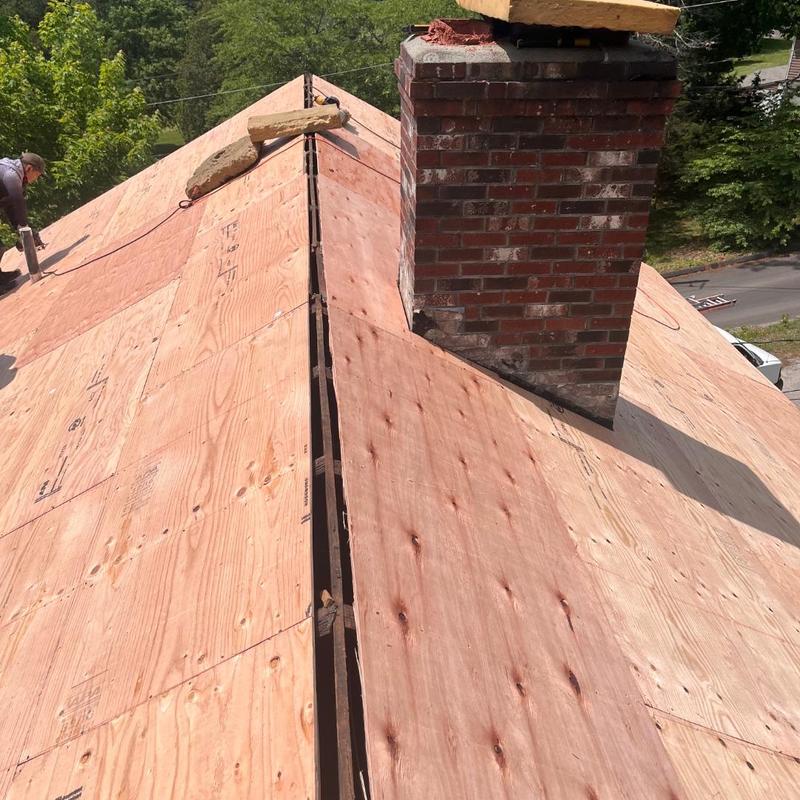 Roof decking installation around brick chimney Roof decking installation around brick chimney