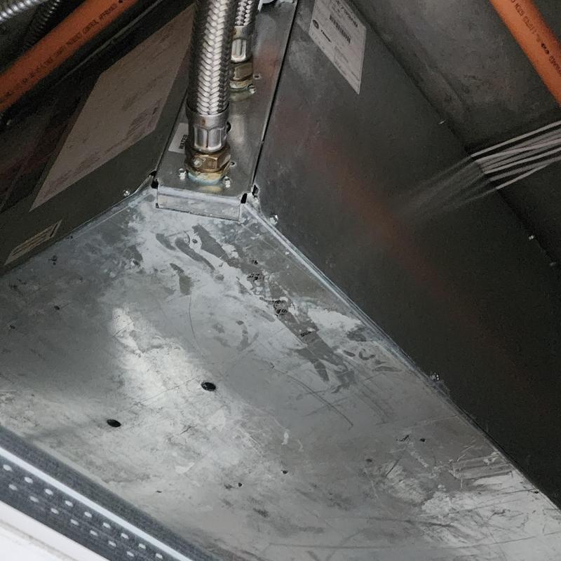 Trane HVAC unit metal housing and piping connections