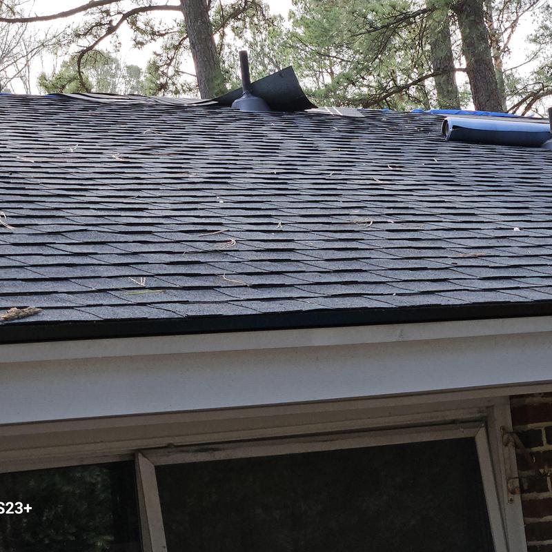Asphalt shingle roof installation with ventilation pipe Asphalt shingle roof installation with ventilation pipe