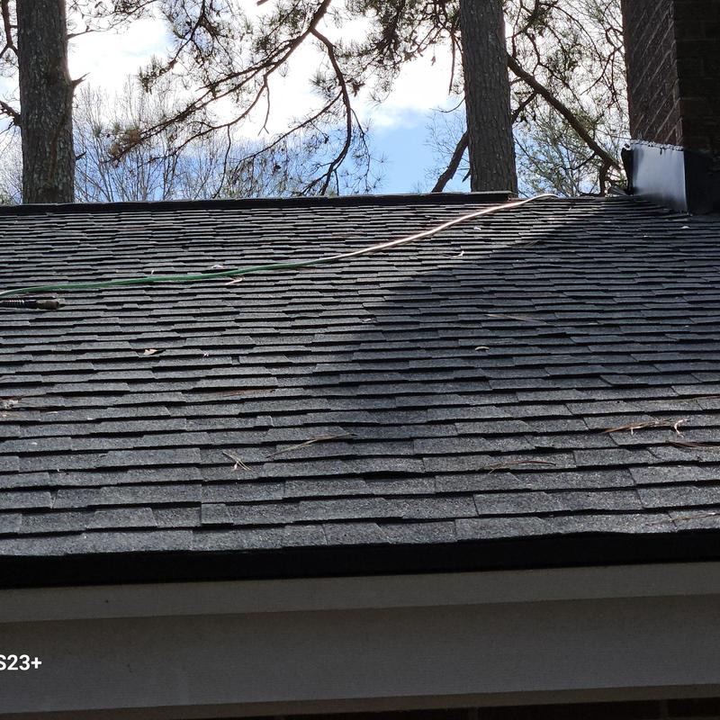 Asphalt shingle roof with hose laid on top Asphalt shingle roof with hose laid on top