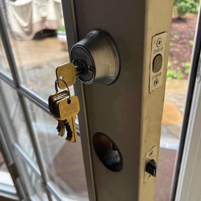 Kwikset deadbolt lock with new keys on exterior door
