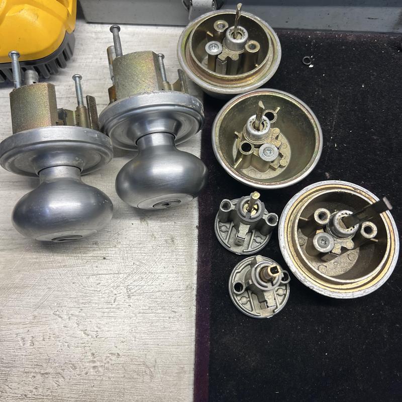 Door knob locks and lock cylinders disassembled for rekeying