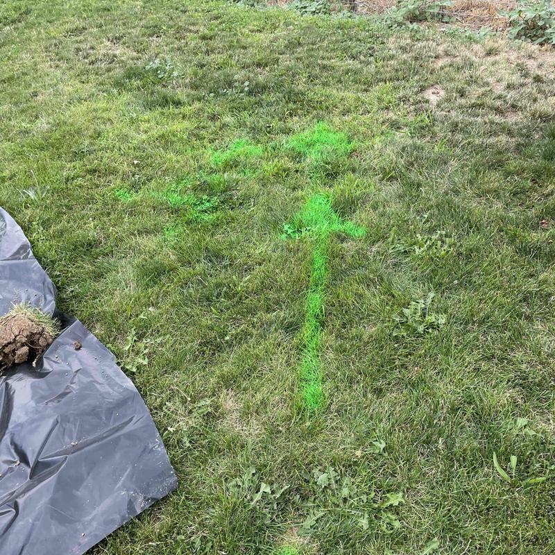 Septic drain field marked with green arrows on lawn