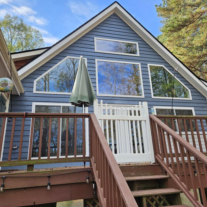 Wooden deck with white safety gate and railing Wooden deck with white safety gate and railing