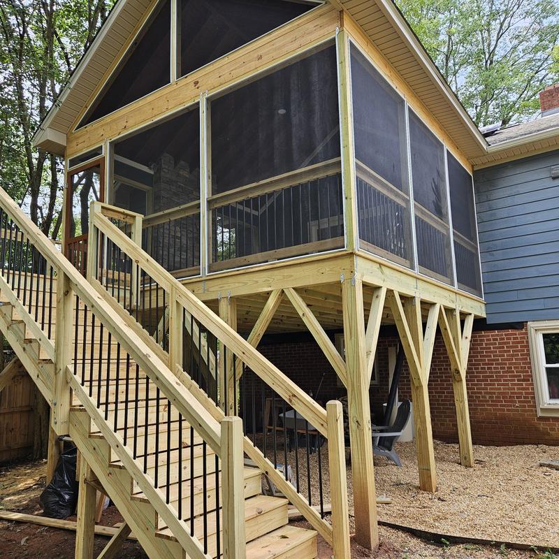Screened deck addition with wooden stairs and railings Screened deck addition with wooden stairs and railings