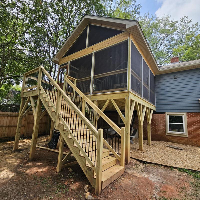 Screened porch deck addition with wooden stairs Screened porch deck addition with wooden stairs