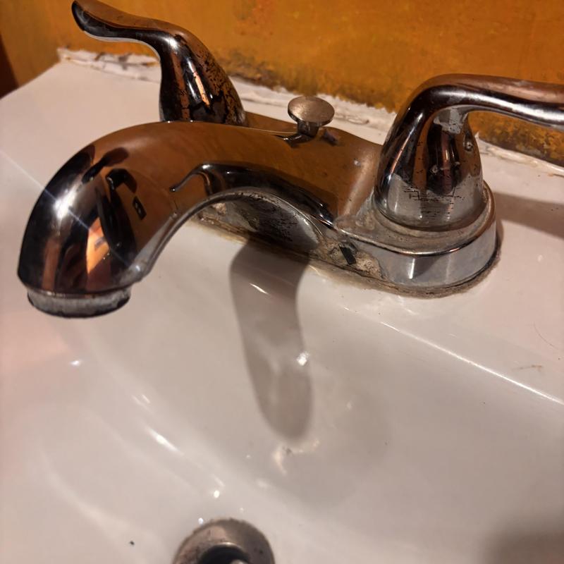 Bathroom sink faucet with mineral buildup and grime