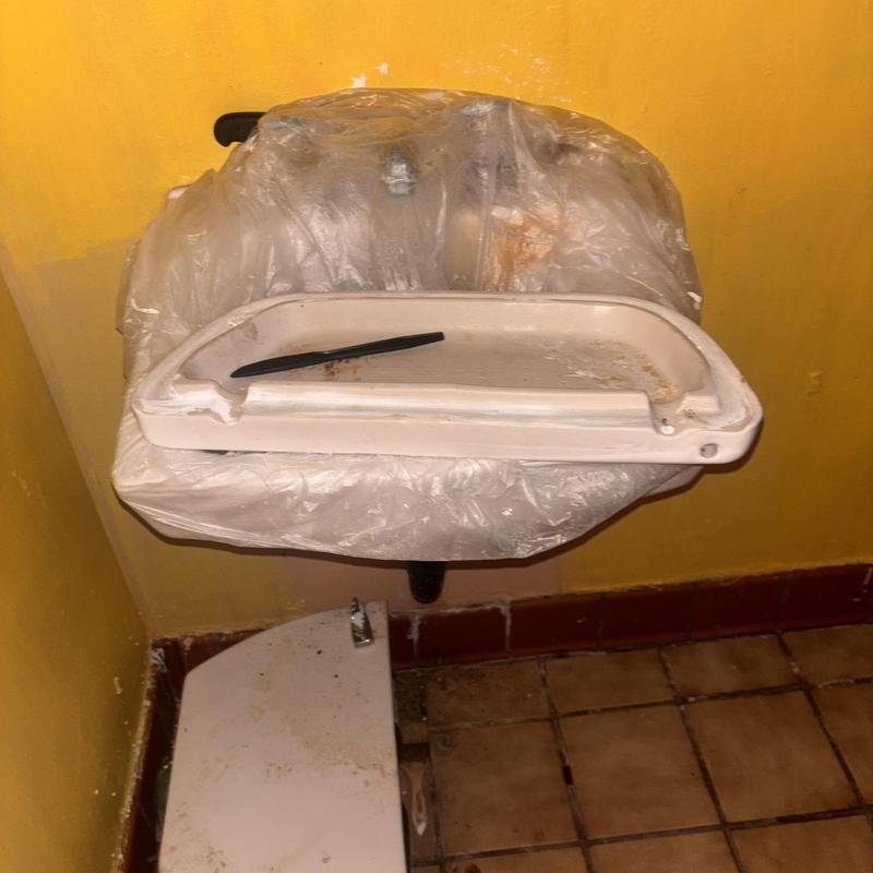 Floor drain cover and trap in a yellow room