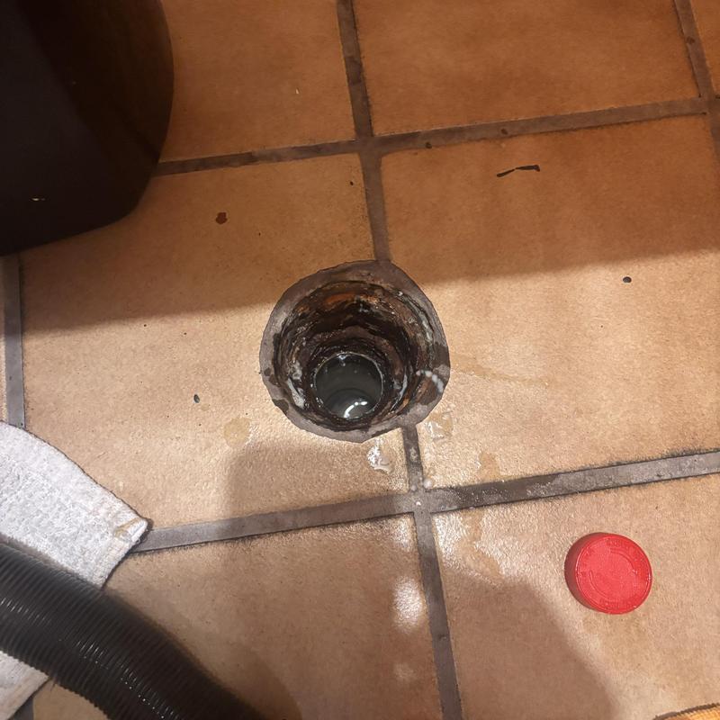 Floor drain with open pipe in tiled floor