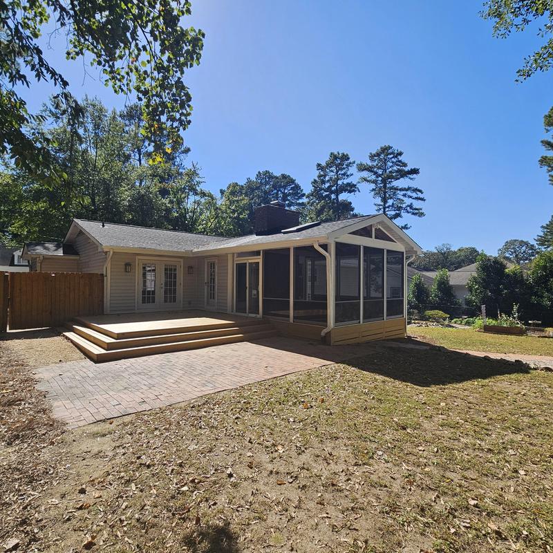 Screened porch and wooden deck home addition in backyard Screened porch and wooden deck home addition in backyard