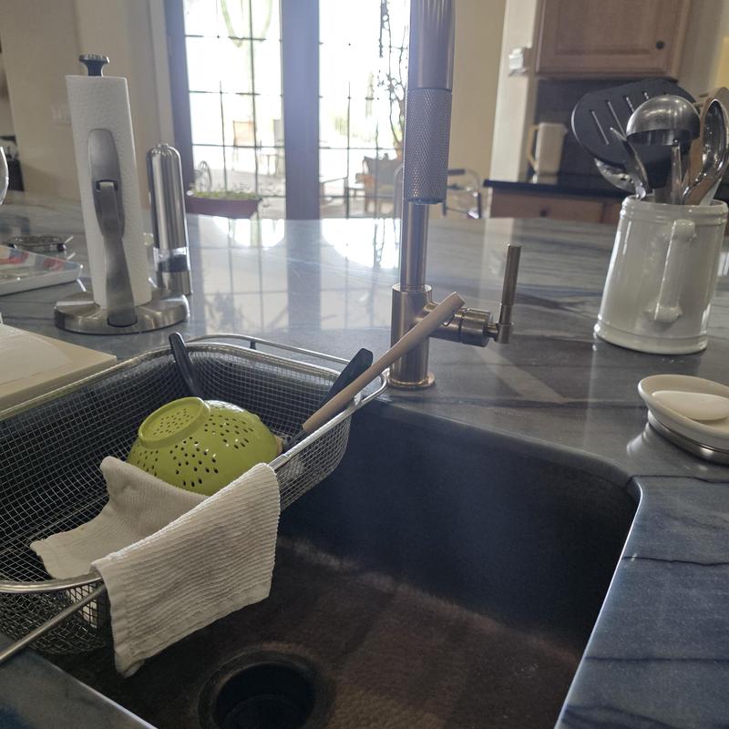 Kitchen sink faucet and countertop setup with utensils Kitchen sink faucet and countertop setup with utensils