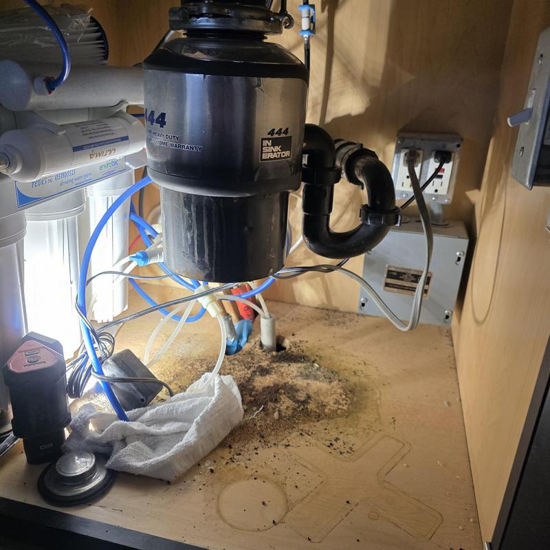 Garbage disposal system under sink with connected pipes Garbage disposal system under sink with connected pipes