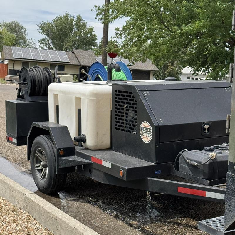 Sewer line jetter trailer with hose reels outdoors