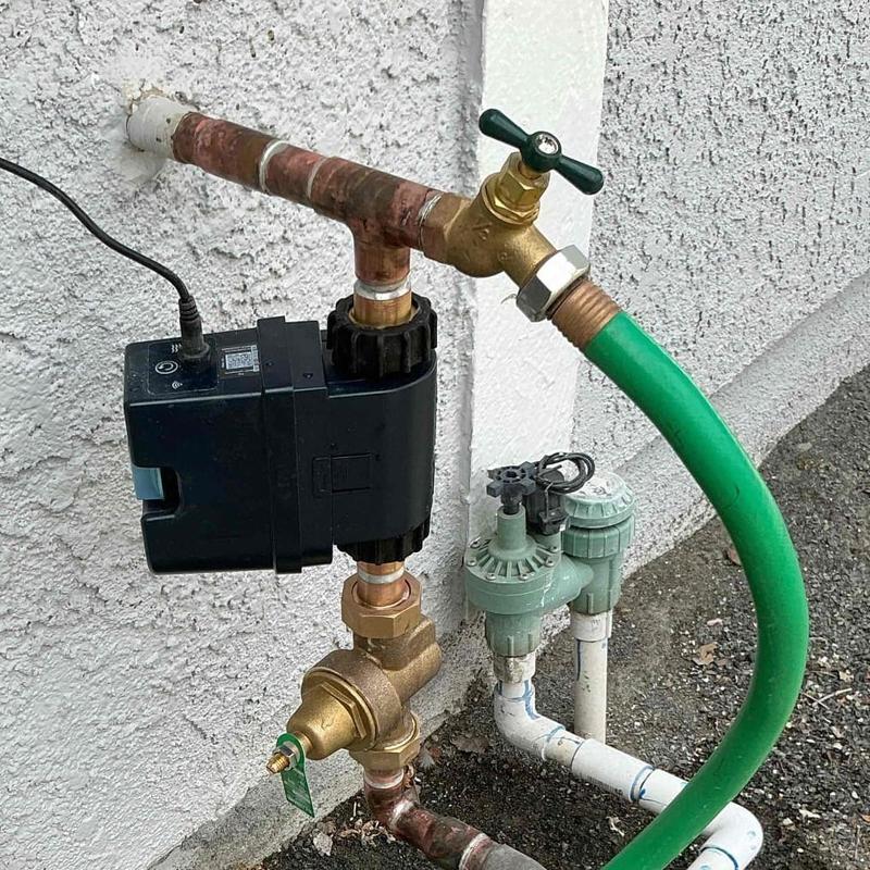 Moen Flo water flow monitor on outdoor pipe