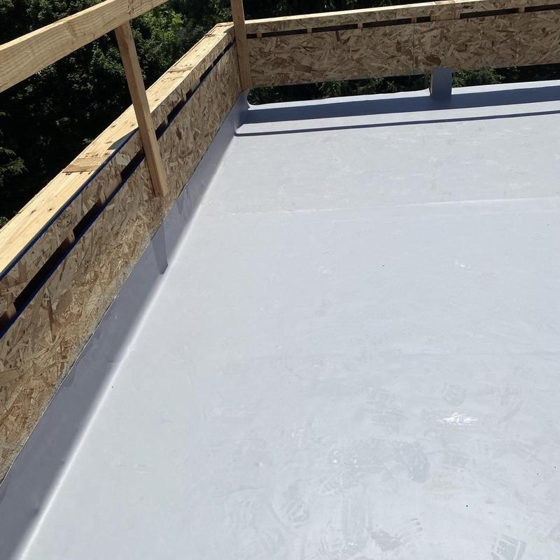 Flat roof membrane installation with wooden guardrails Flat roof membrane installation with wooden guardrails