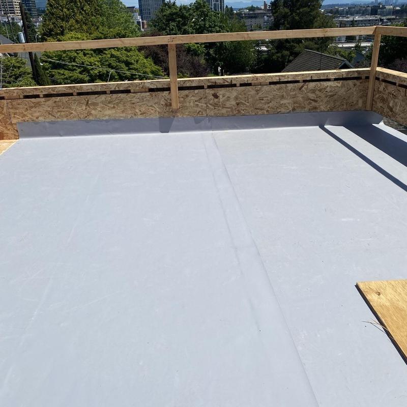 Flat roof membrane installation with wooden guardrails Flat roof membrane installation with wooden guardrails